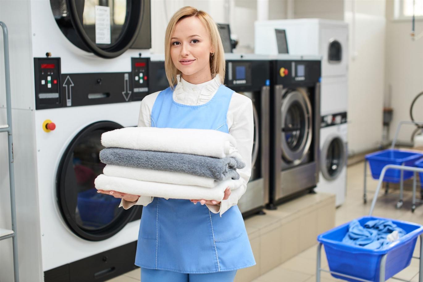 portrait-laundry-worker-background-clothes-hangers-dry-cleaning